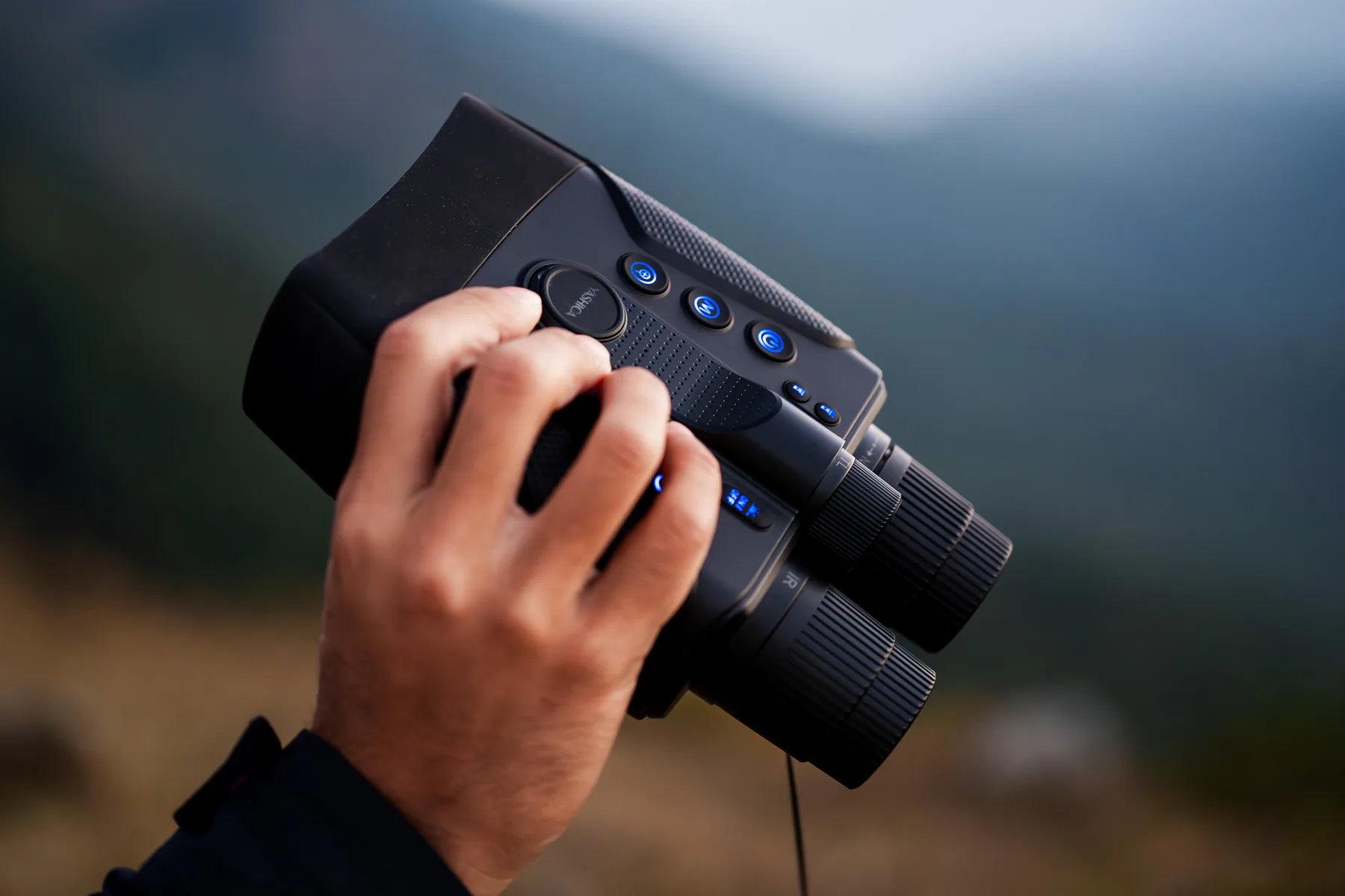 Yashica Vision held in hand with its blue-lit buttons